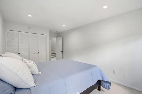 a bedroom with a bed and a lamp