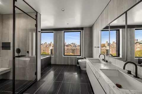 a bathroom with a tub sink and mirror