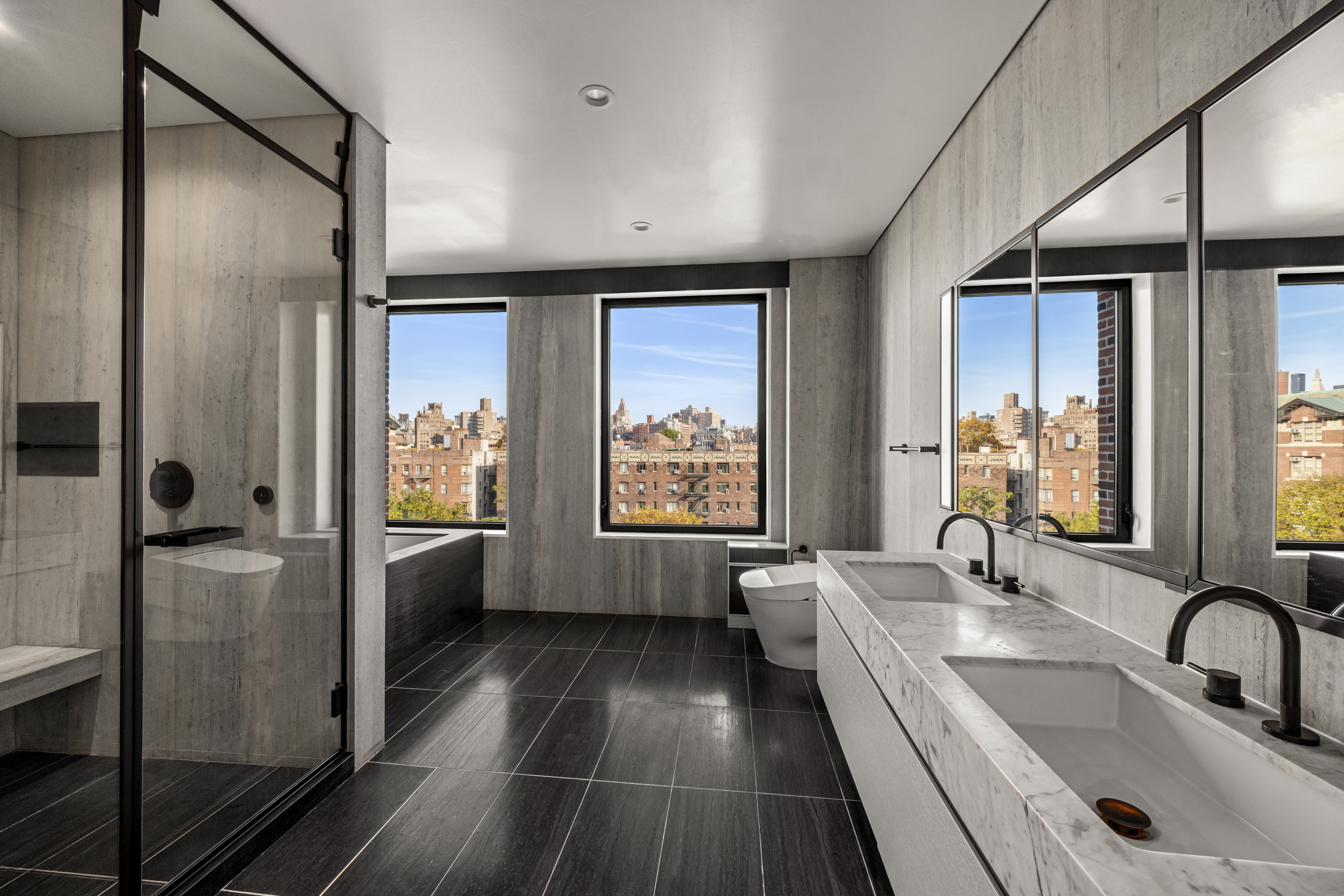 100 Barrow Street, Unit 7/8A Manhattan, NY 10014 - Photo 15 of 23 a bathroom with a tub sink and mirror