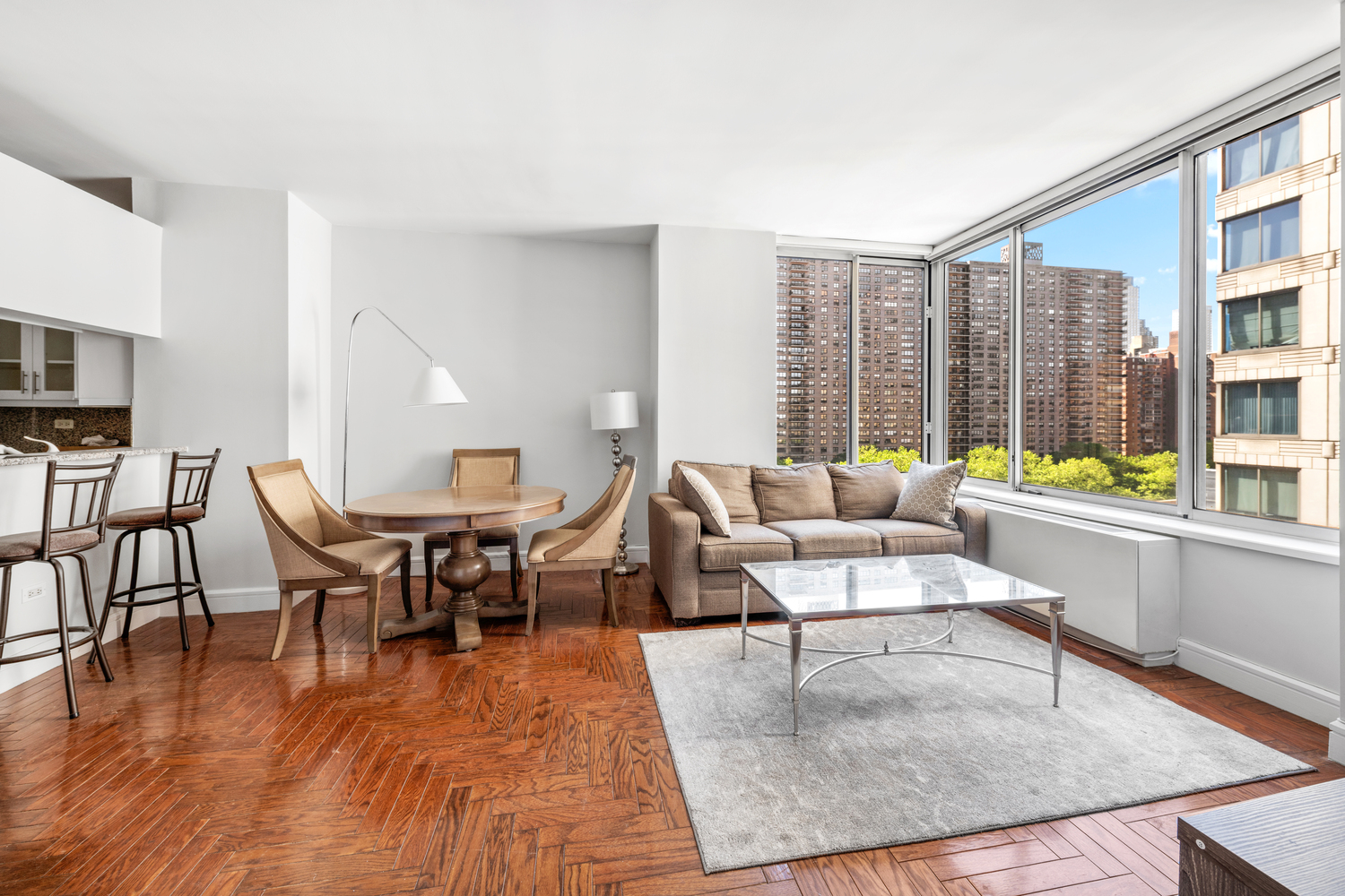 200 Riverside Boulevard, Unit 9F Manhattan, NY 10069 - Photo 2 of 12 a living room with fireplace furniture and a large window