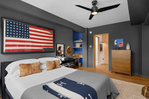 a bedroom with a bed closet and a window