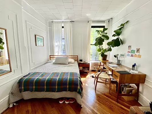 a bedroom with a bed and a table