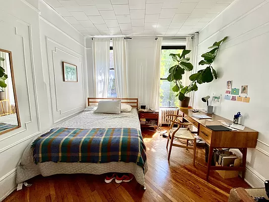 351 7th Avenue, Unit 2 Brooklyn, NY 11215 - Photo 7 of 10 a bedroom with a bed and a table