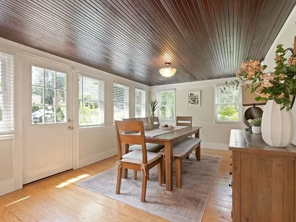 a view of a dining room with furniture and a potted plant