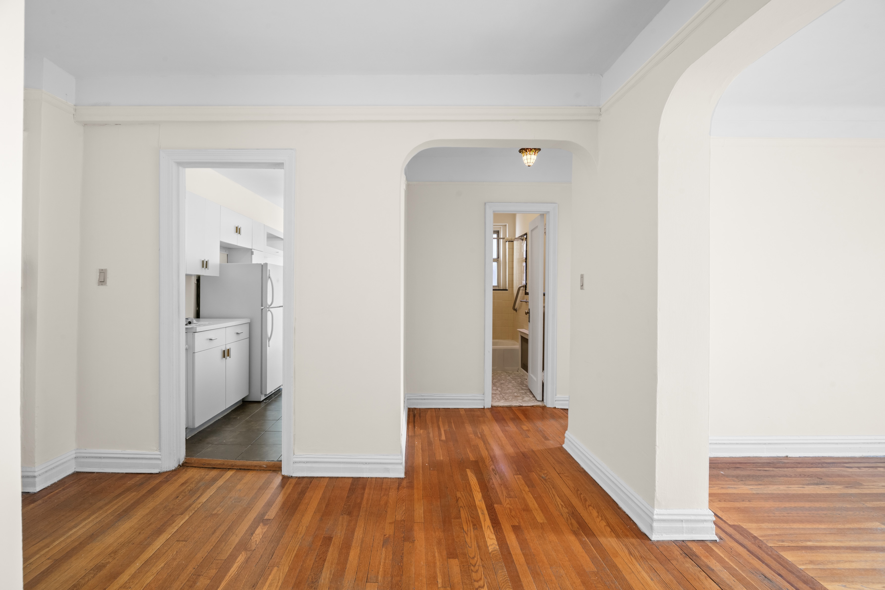 40 Tehama Street, Unit 6E Brooklyn, NY 11218 - Photo 4 of 16 a view of a room with wooden floor and a bathroom