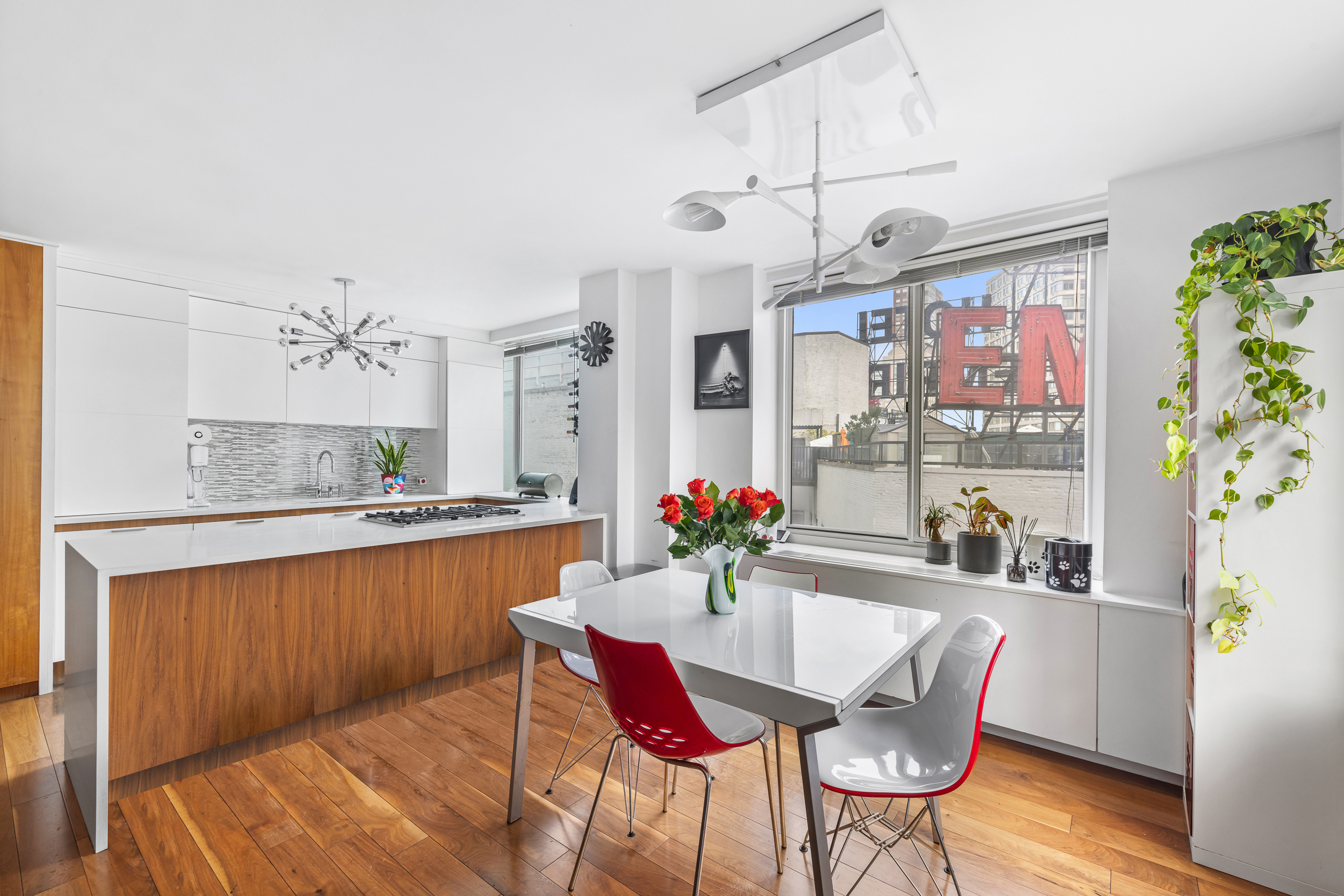 61 West 62nd Street, Unit 16D Manhattan, NY 10023 - Photo 3 of 11 a dining room with stainless steel appliances kitchen island granite countertop furniture and a kitchen view