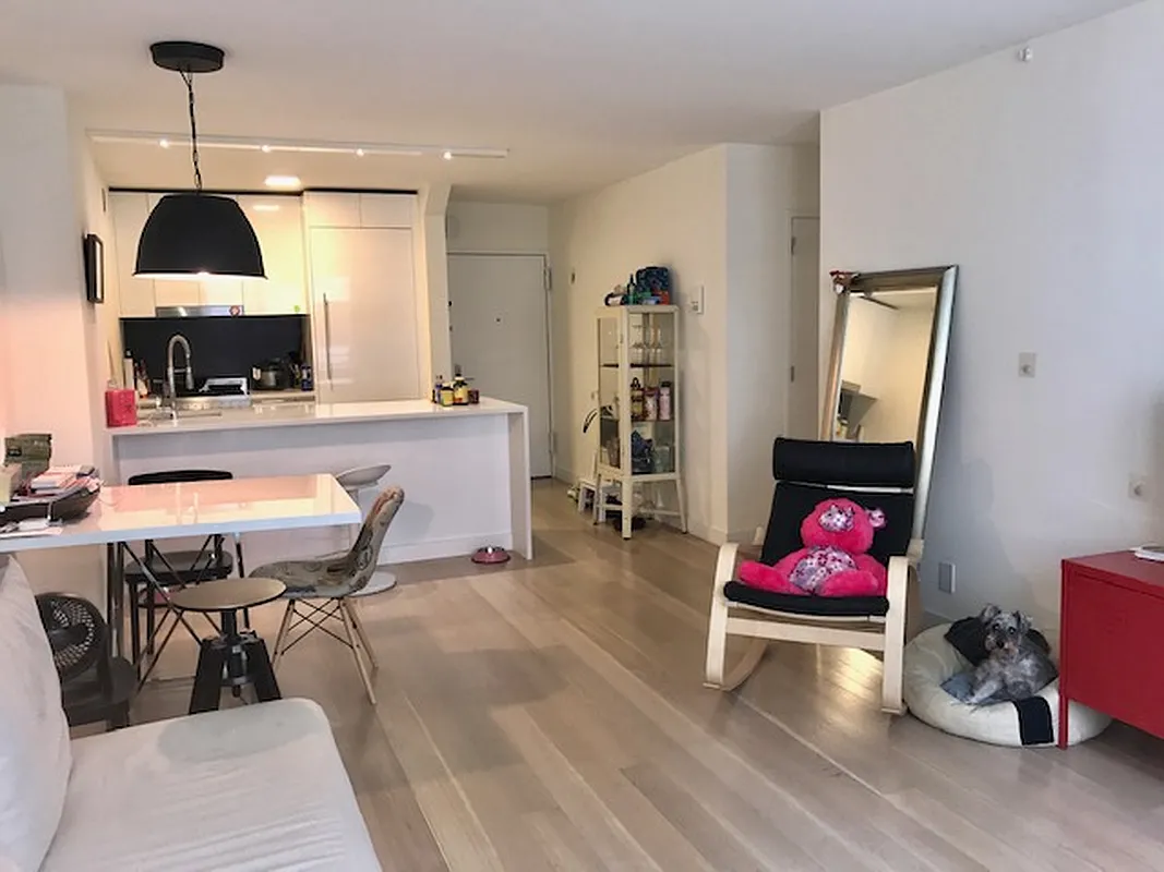 301 West 53rd Street, Unit 3I Manhattan, NY 10019 - Photo 2 of 14 a dining room with furniture and wooden floor