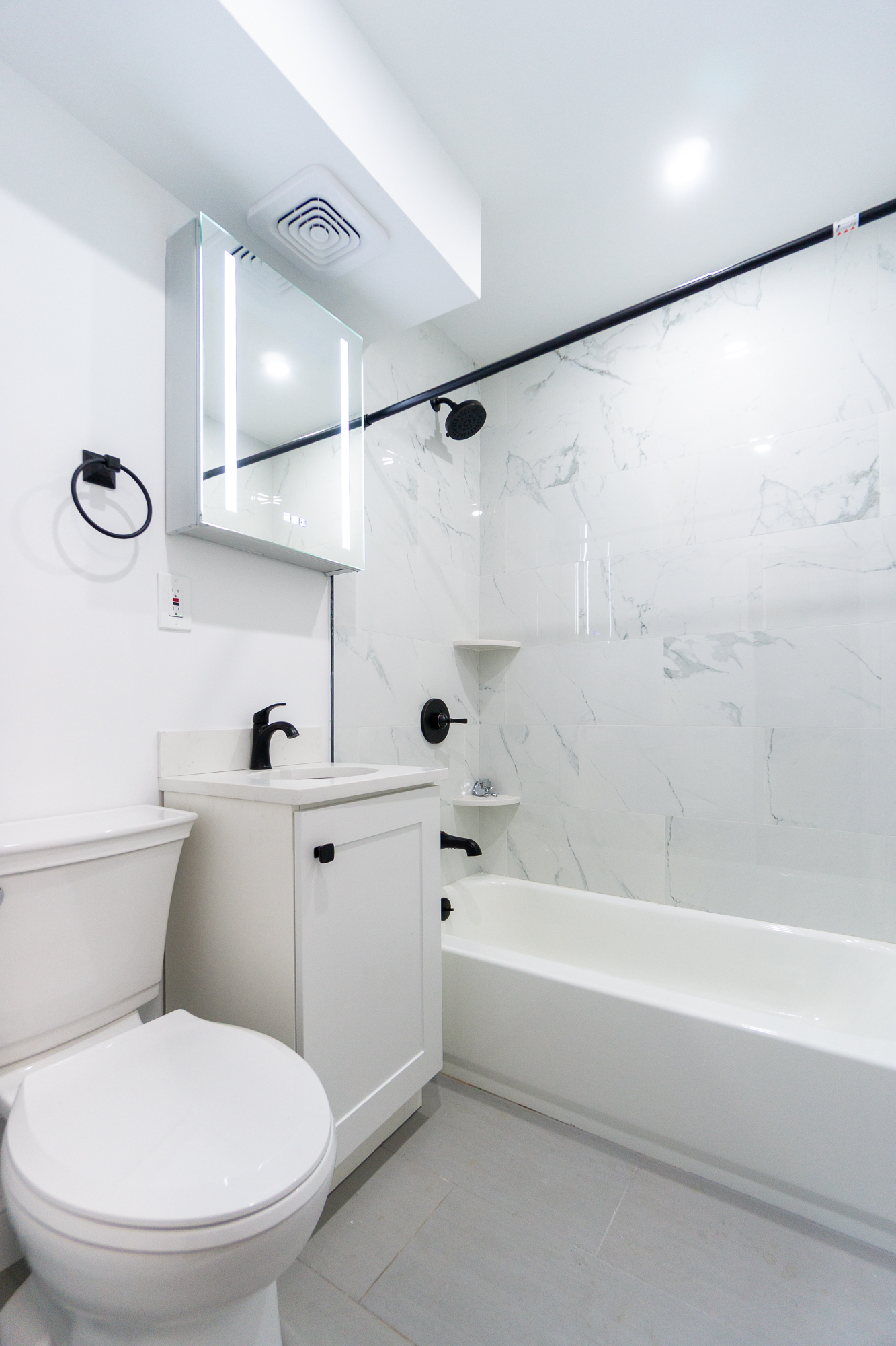 205 2nd Avenue, Unit 3B Manhattan, NY 10003 - Photo 8 of 9 a bathroom with a toilet a sink and a shower