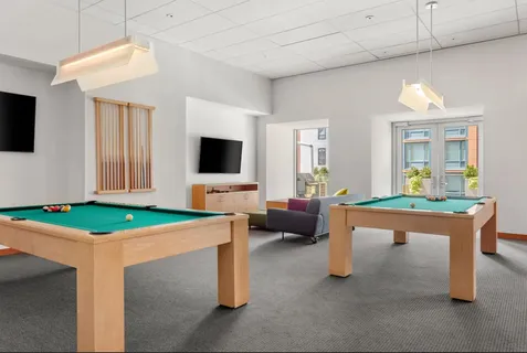 a room with furniture a flat screen tv and a table