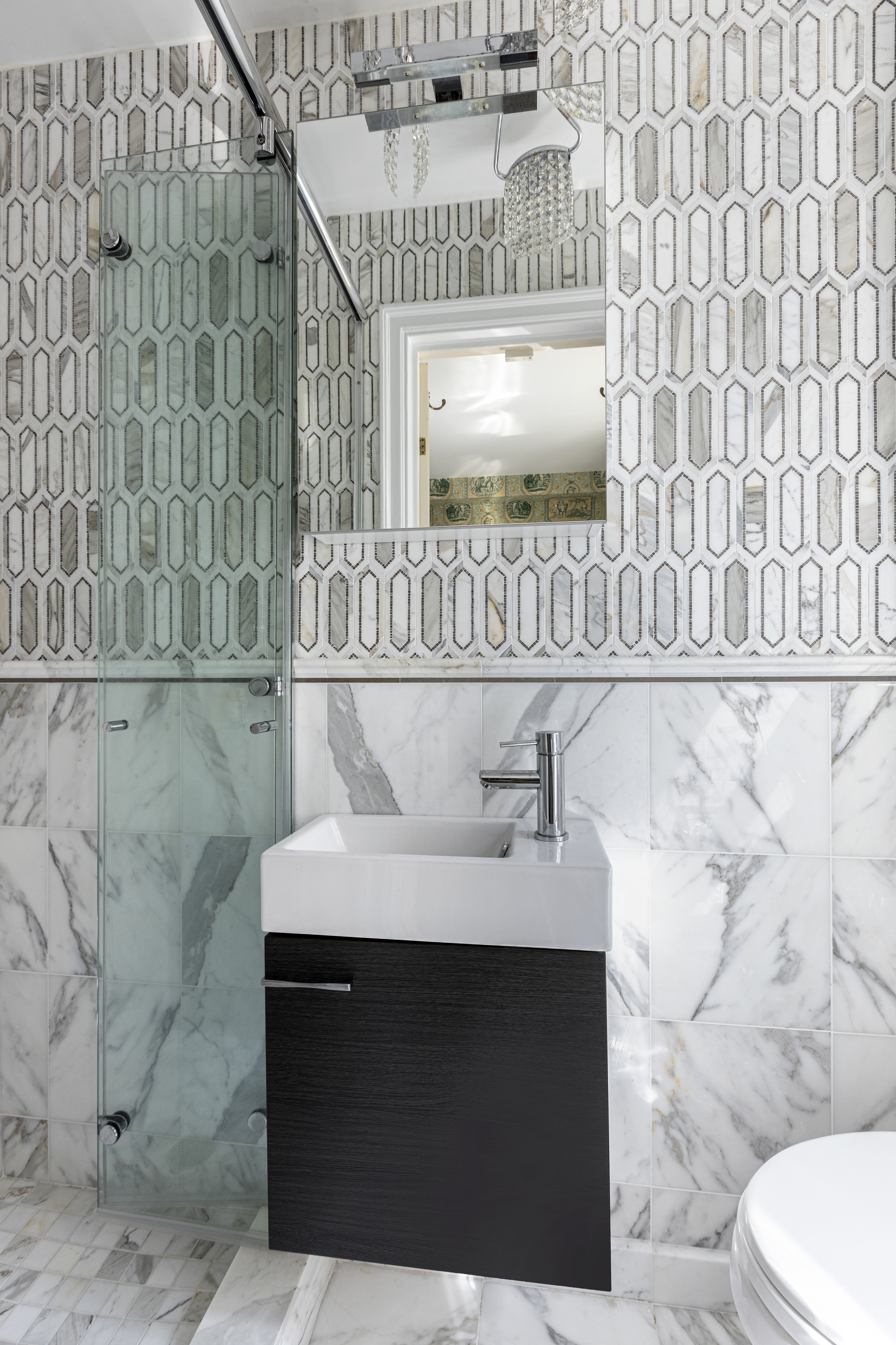 71 East 77th Street, Unit 9C Manhattan, NY 10075 - Photo 10 of 14 a bathroom with a sink and a mirror