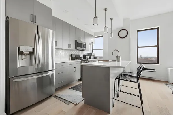 a kitchen with a refrigerator sink and cabinets