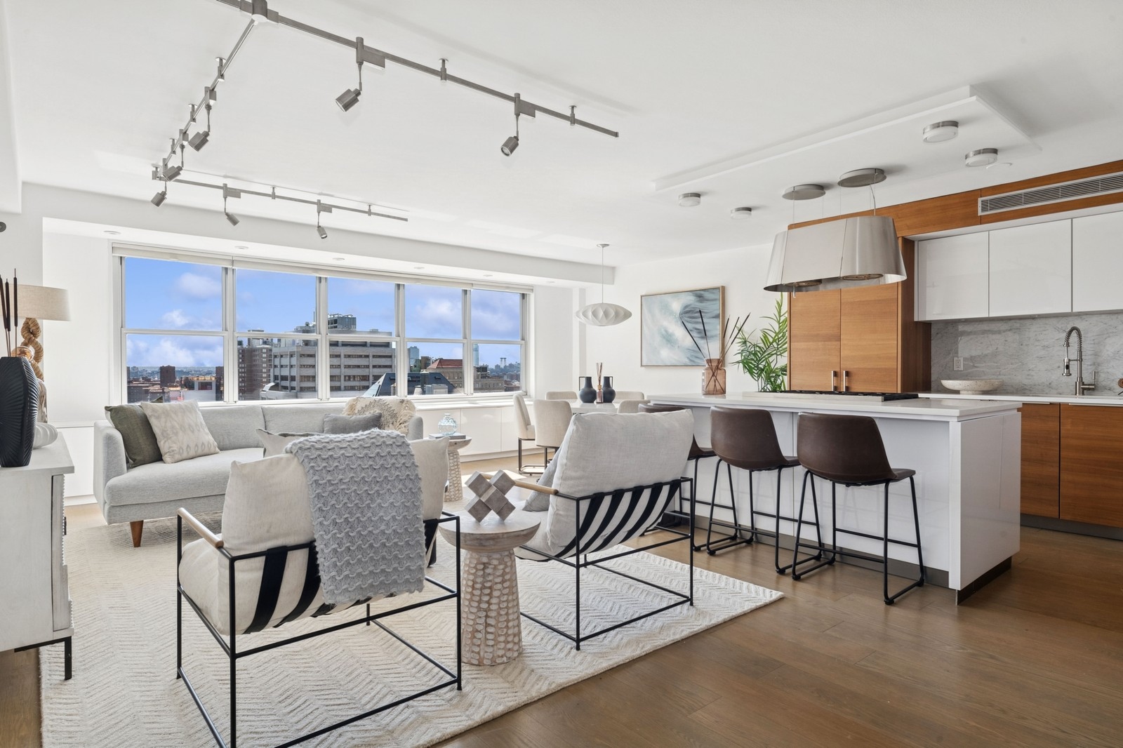 205 3rd Avenue, Unit 21H Manhattan, NY 10003 - Photo 1 of 17 a living room with couches and kitchen view