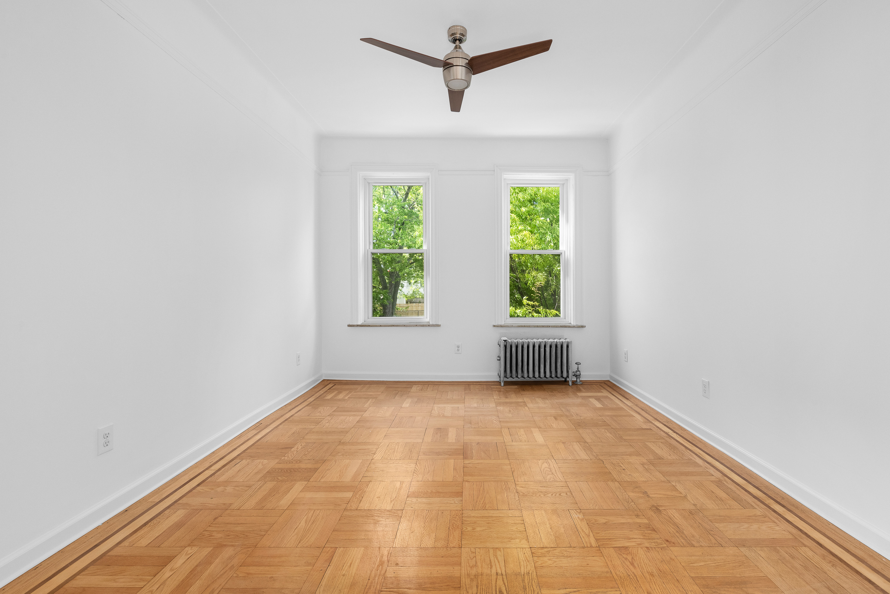 124 Terrace Place, Unit 2 Brooklyn, NY 11218 - Photo 3 of 8 an empty room with a window and a ceiling fan