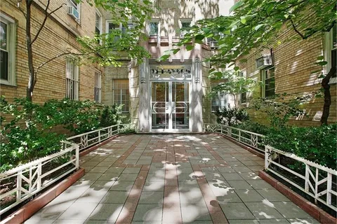 a view of a pathway with a garden