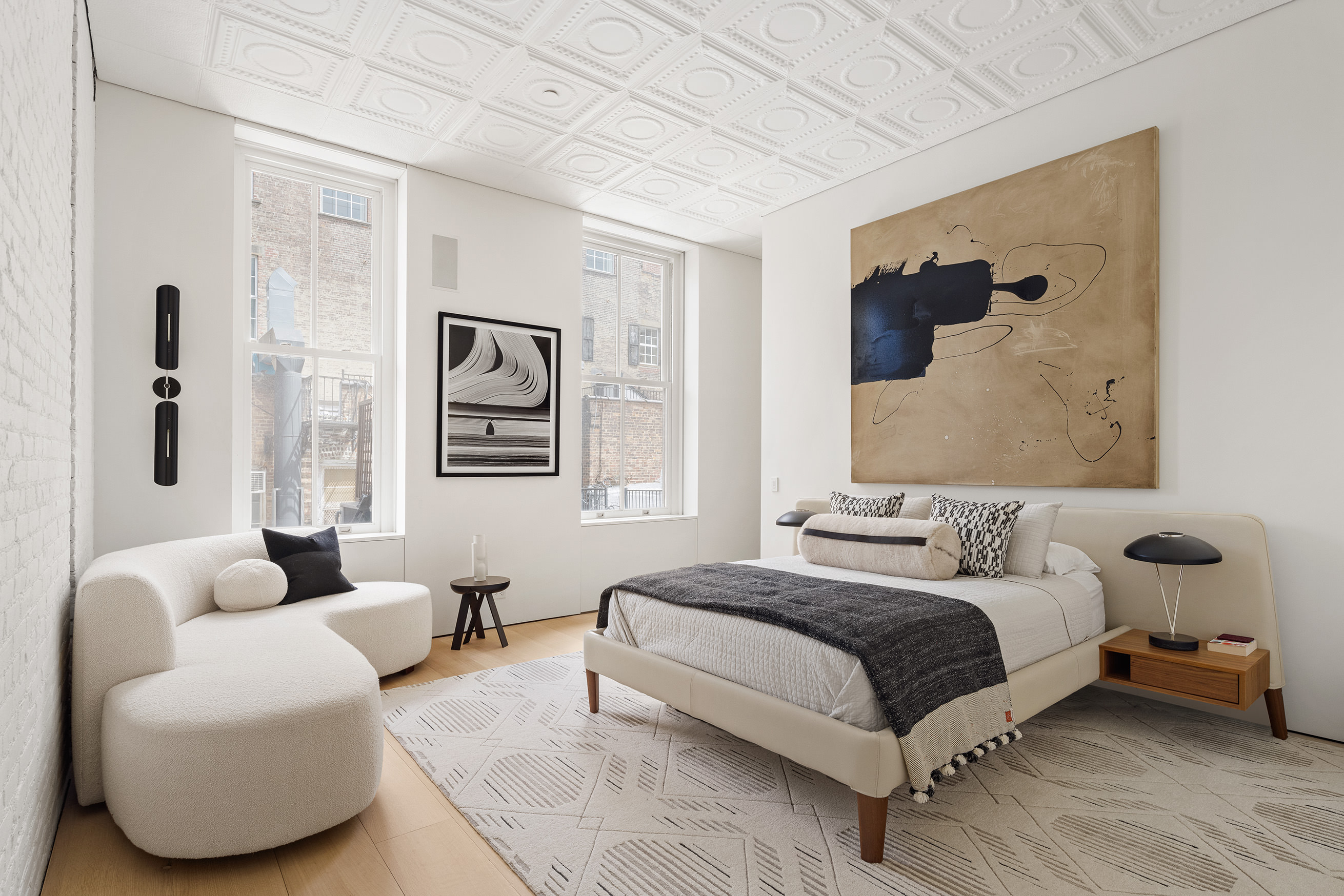 100 Grand Street, Unit 4 Manhattan, NY 10013 - Photo 6 of 13 a bedroom with a bed couches and window