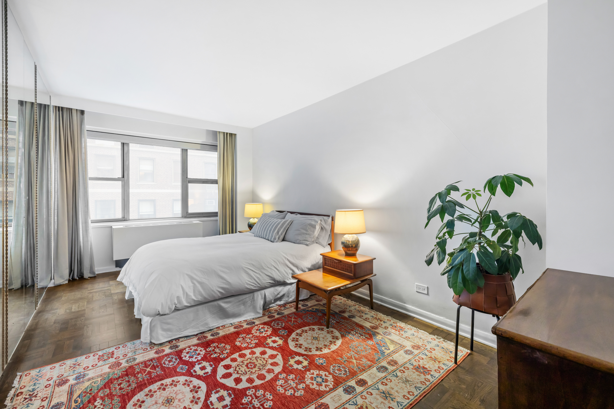 16 Sutton Place, Unit 11A Manhattan, NY 10022 - Photo 7 of 19 a bedroom with two beds and a potted plant