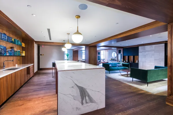 a large kitchen with stainless steel appliances kitchen island granite countertop a large counter top and wooden floors