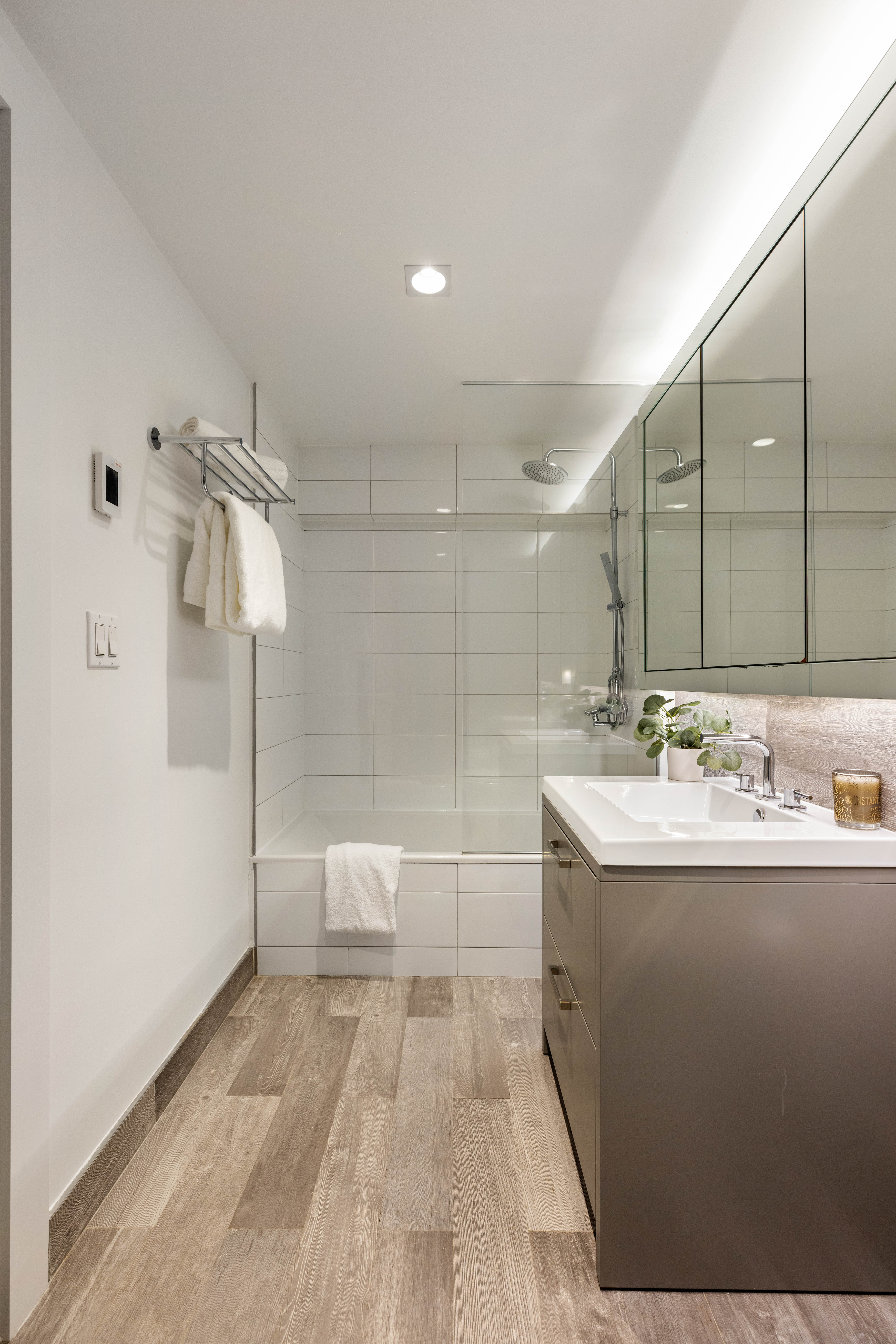 172 North 10th Street, Unit 3D Brooklyn, NY 11211 - Photo 12 of 16 a bathroom with a sink a toilet and shower