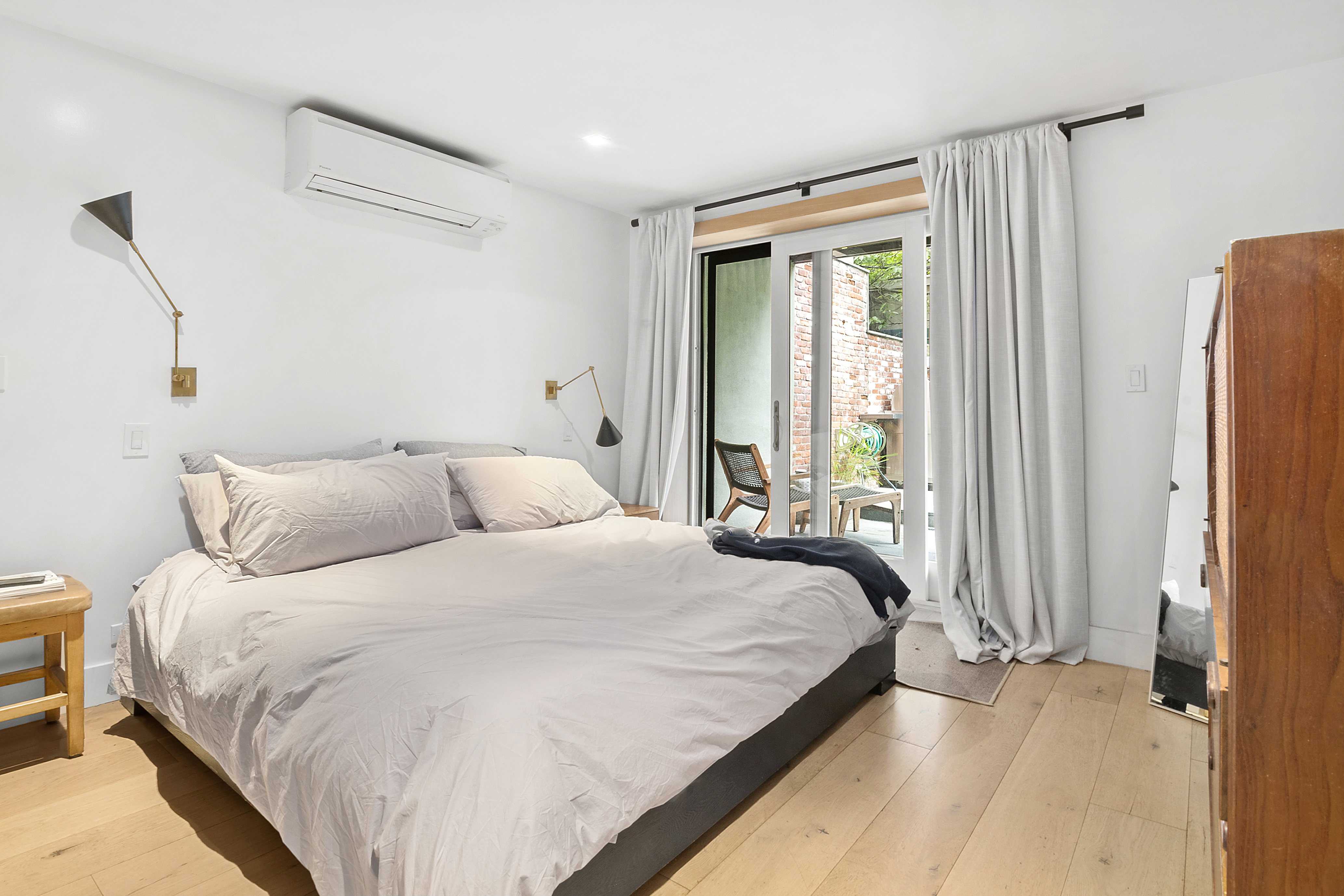 87 Monroe Street Brooklyn, NY 11216 - Photo 19 of 26 a bedroom with a bed and a large window