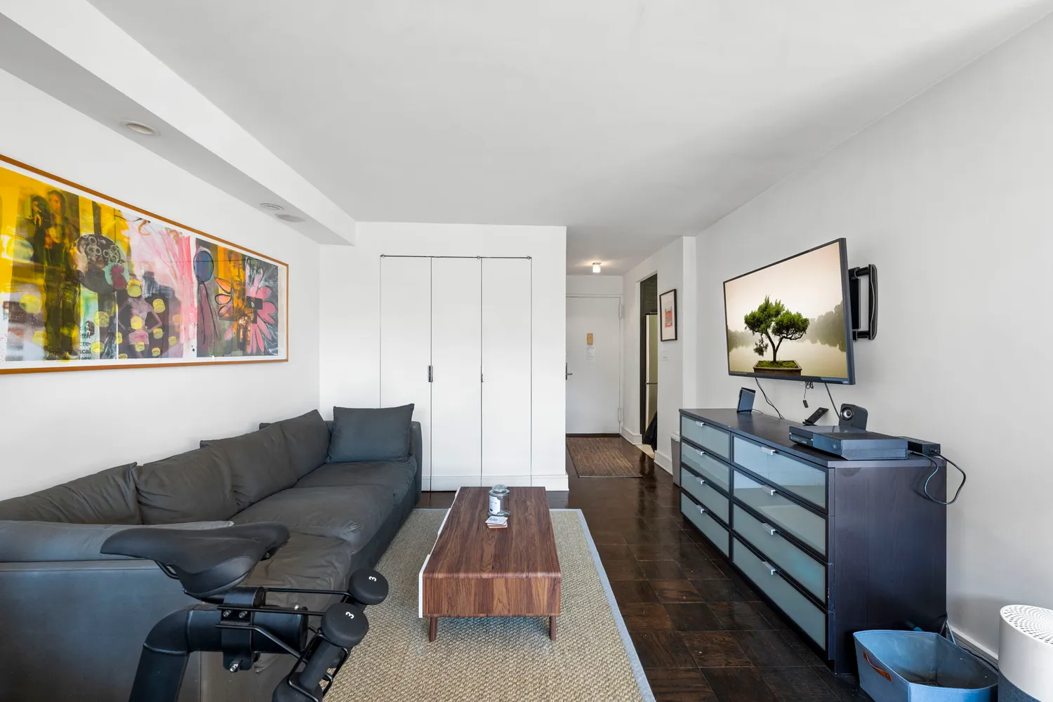 a living room with furniture and wooden floor