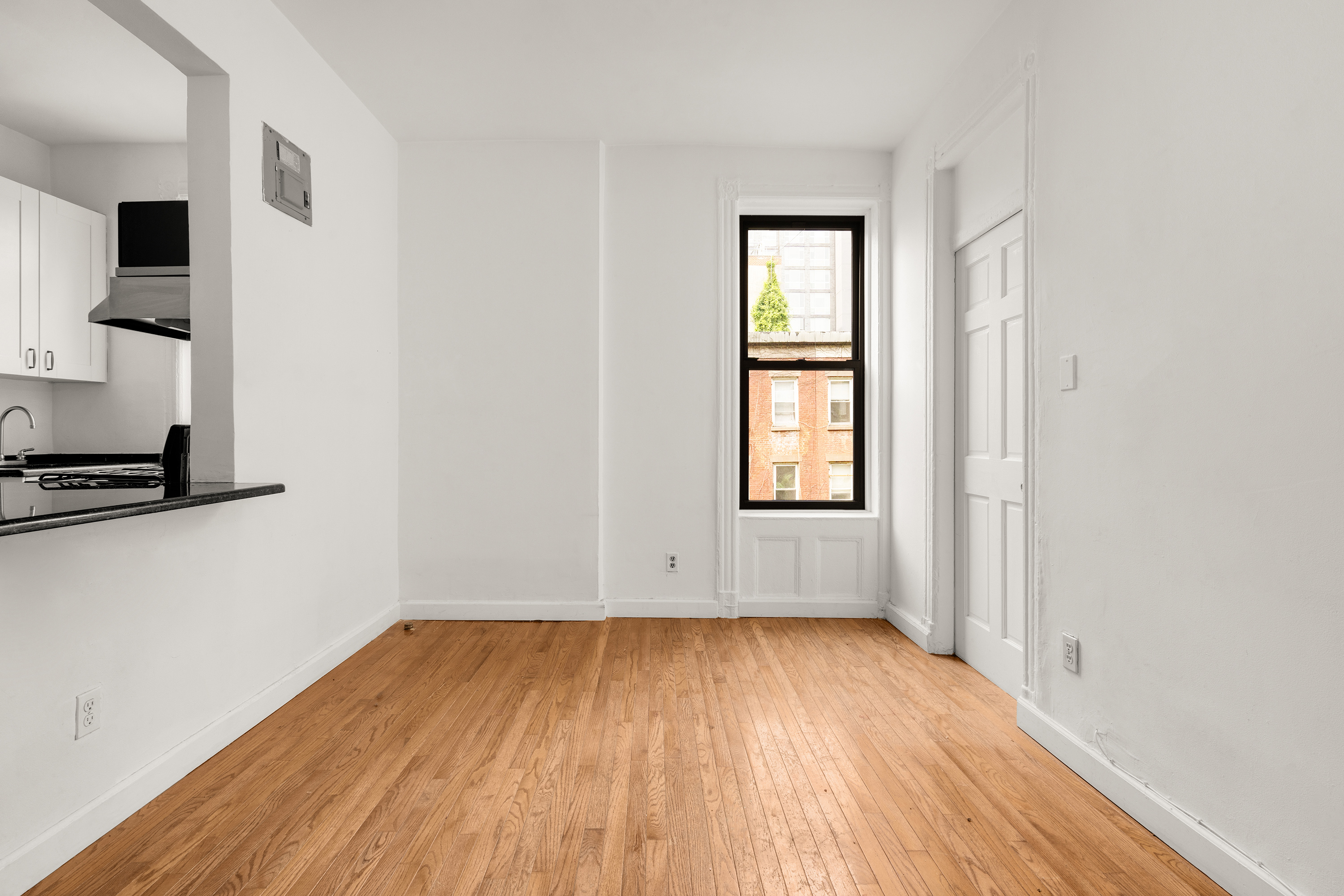 327 East 3rd Street, Unit 2E Manhattan, NY 10009 - Photo 1 of 5 an empty room with wooden floor and windows