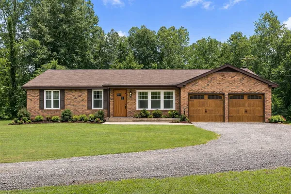 a front view of a house with a yard and garage