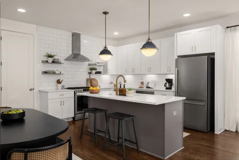 a kitchen with a sink a center island and cabinets