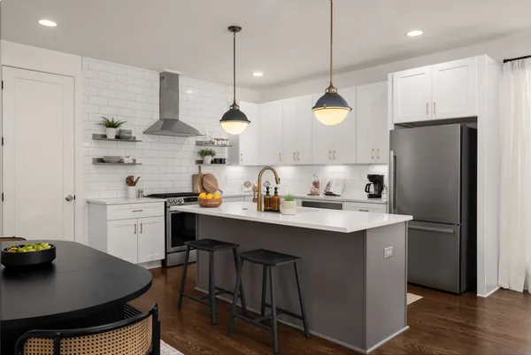 a kitchen with a sink a center island and cabinets