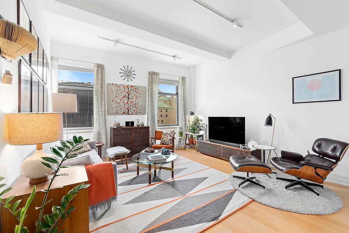 a living room with furniture fireplace and a flat screen tv