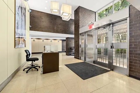 a living room with a large window and furniture