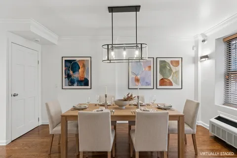 a view of a dining room with furniture wooden floor and a chandelier