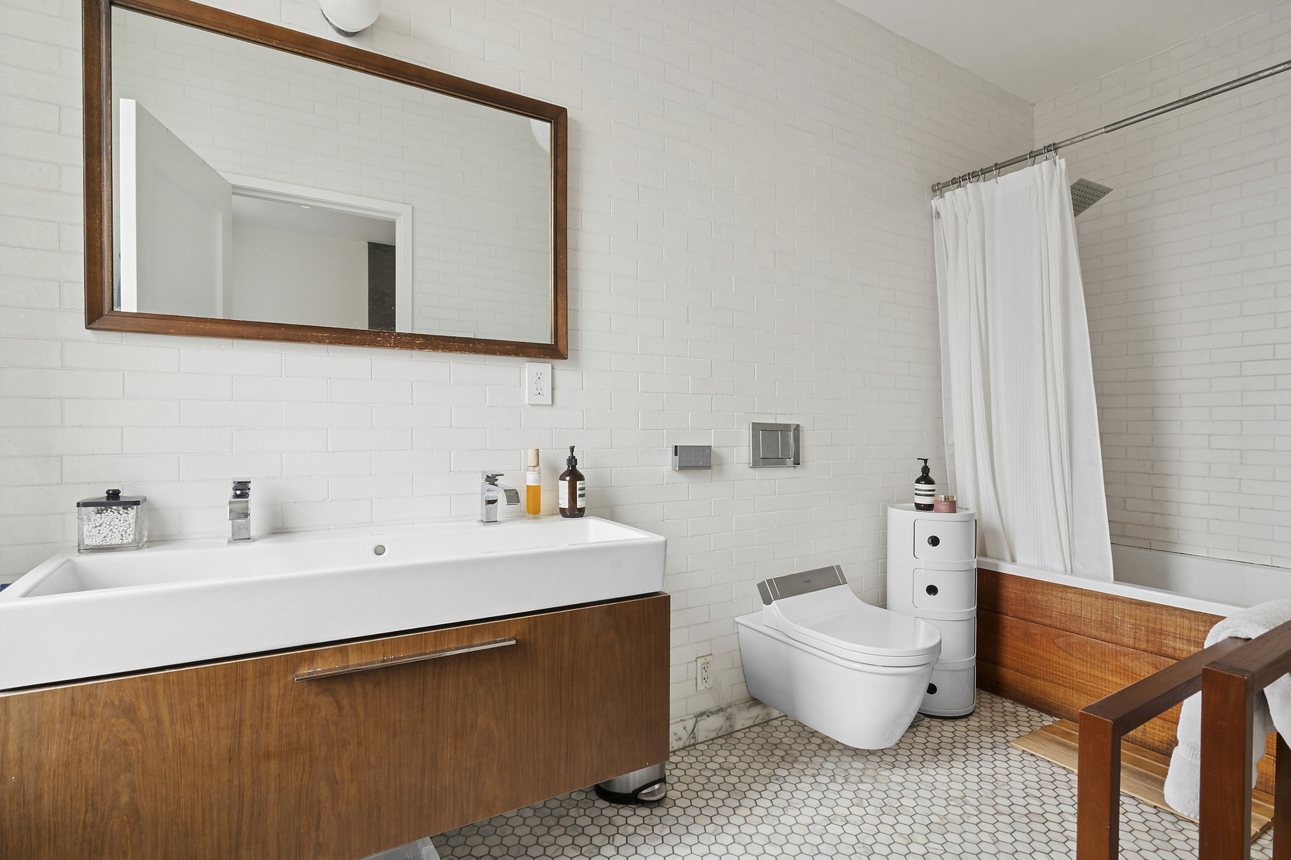 581 Greene Avenue, Unit 2 Brooklyn, NY 11216 - Photo 6 of 16 a bathroom with a sink and a mirror