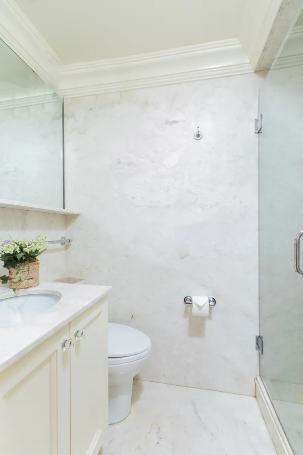 a bathroom with a sink a toilet and shower