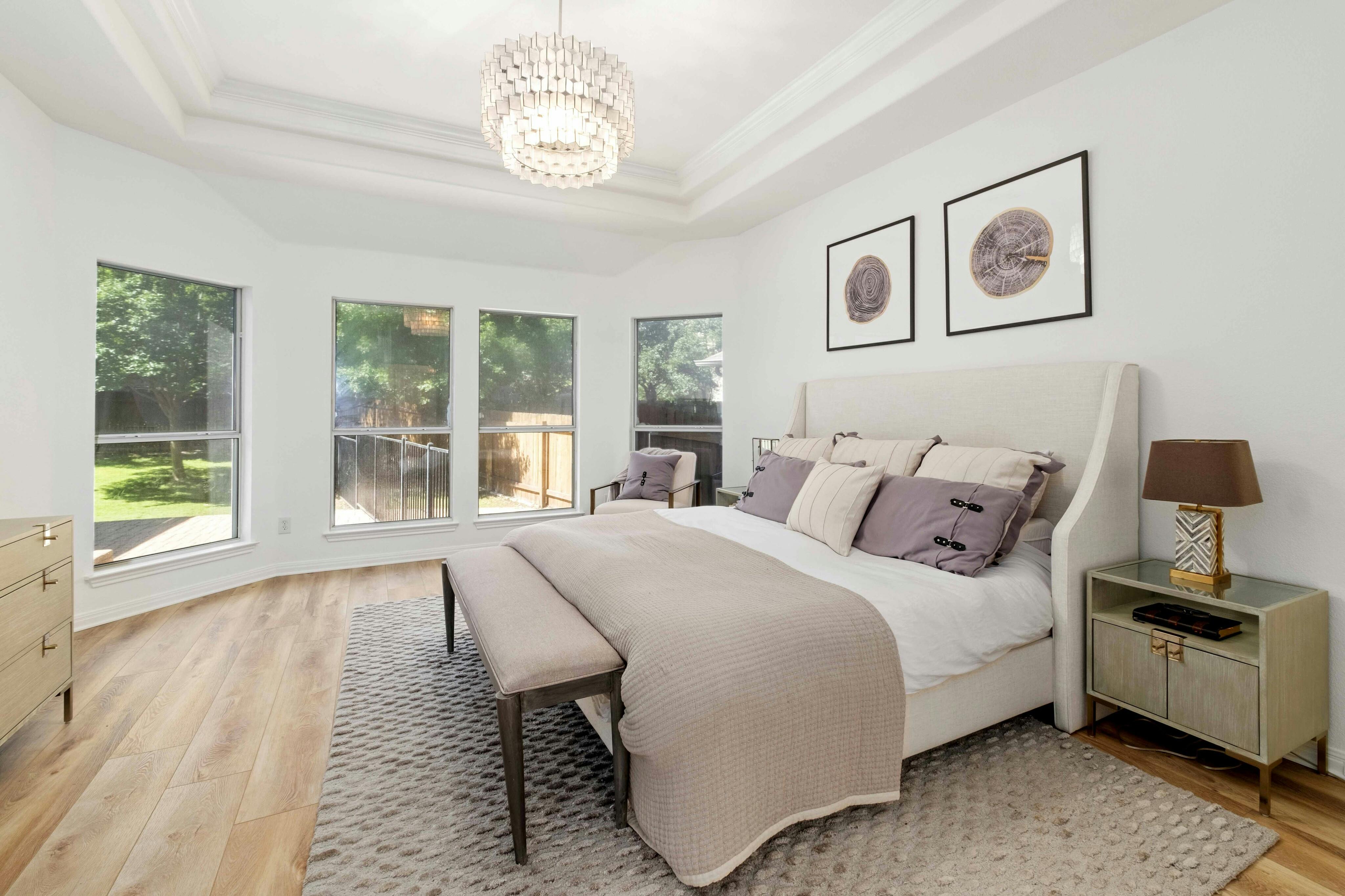 10608 Pointe View Drive Austin, TX 78738 - Photo 18 of 46 a spacious bedroom with a bed and a large window