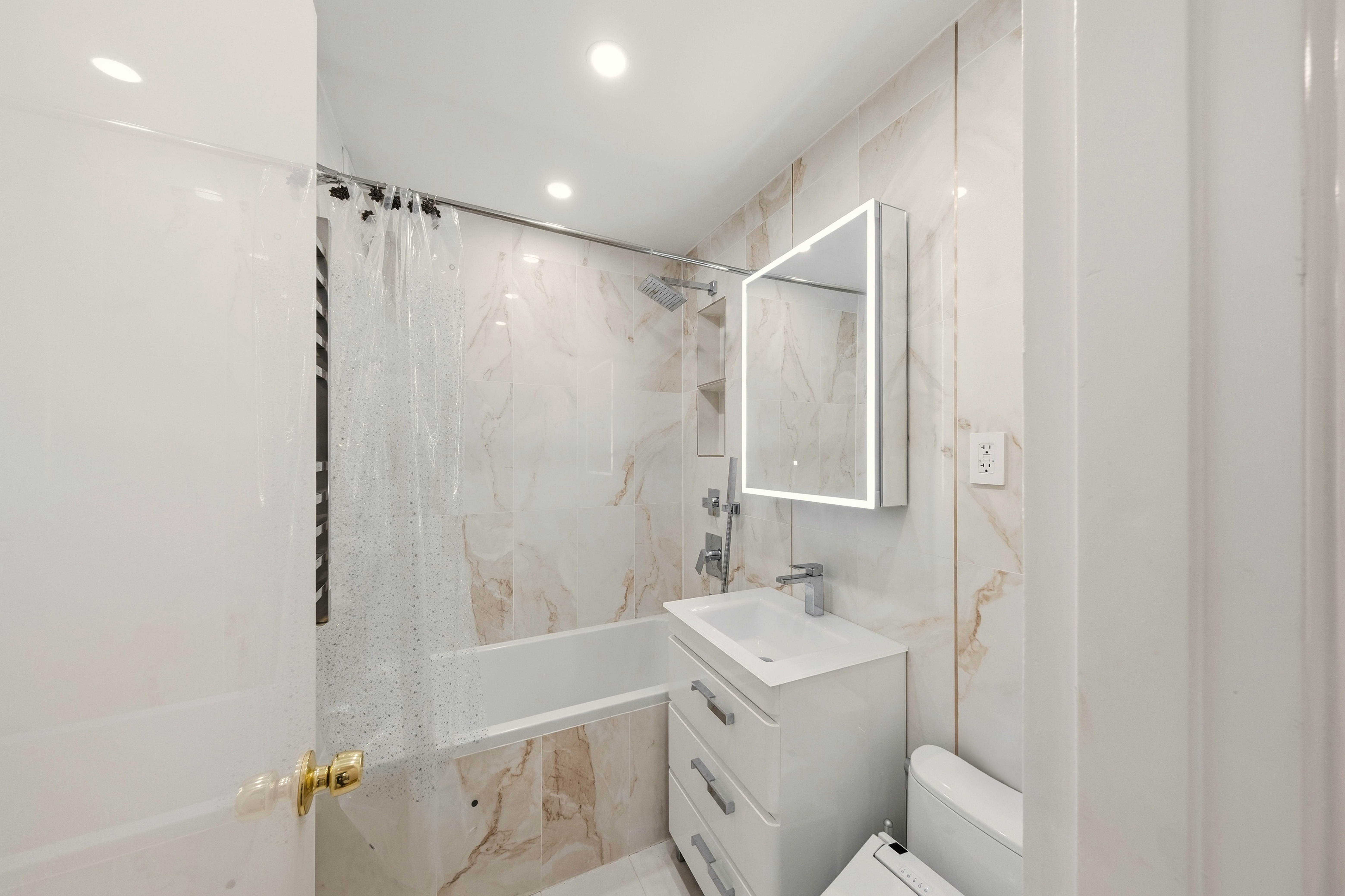 1577 East 17th Street, Unit 2F Brooklyn, NY 11230 - Photo 10 of 21 a bathroom with a sink toilet and shower