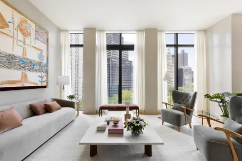 a living room with furniture and large windows