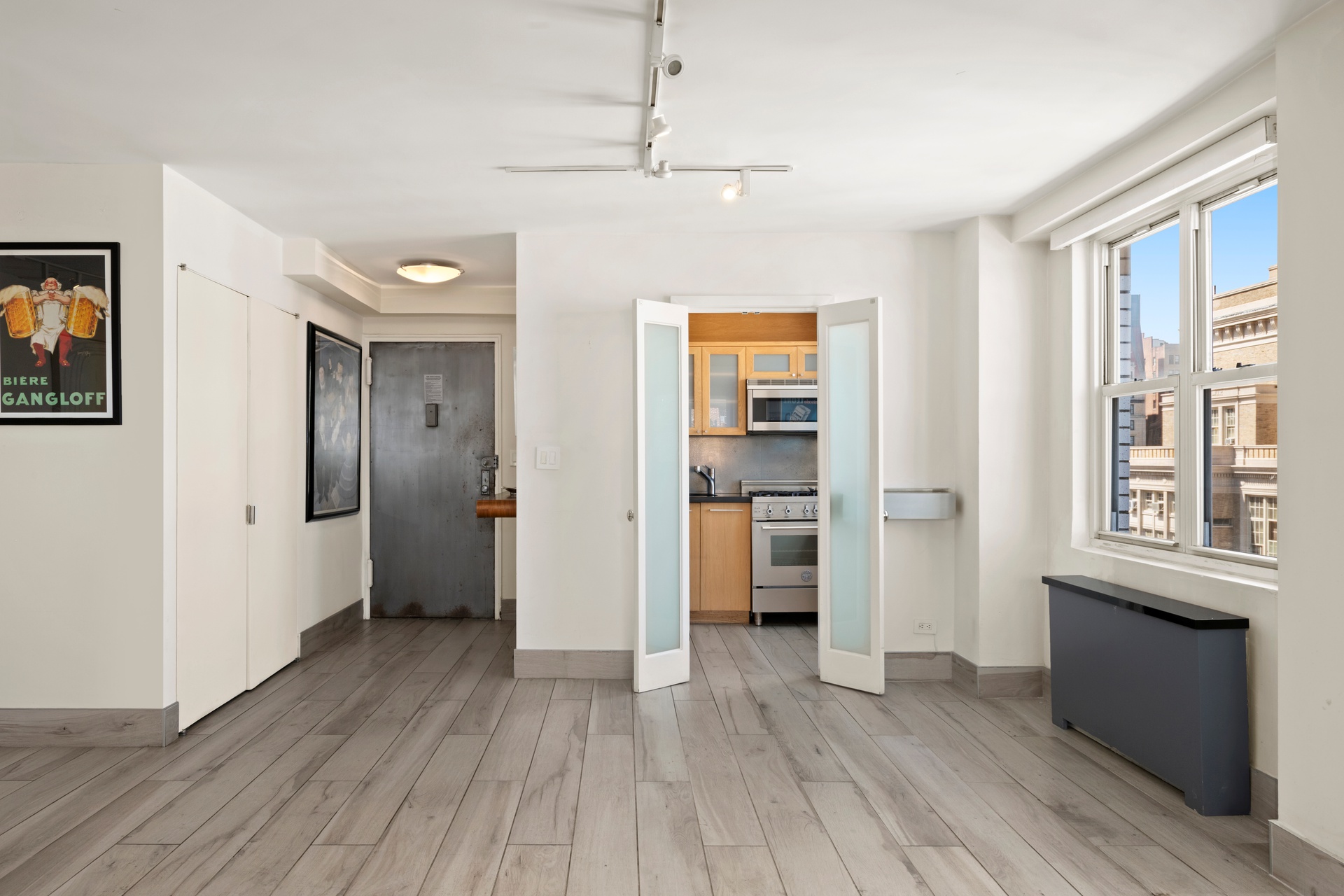 142 East 16th Street, Unit 22B Manhattan, NY 10003 - Photo 7 of 15 a view of empty room with wooden floor and fan