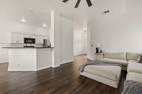 a living room with furniture and kitchen view