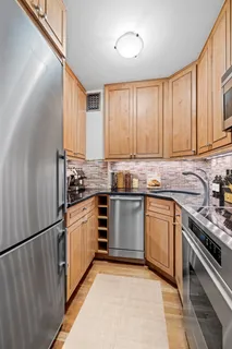 a kitchen with granite countertop stainless steel appliances and cabinets