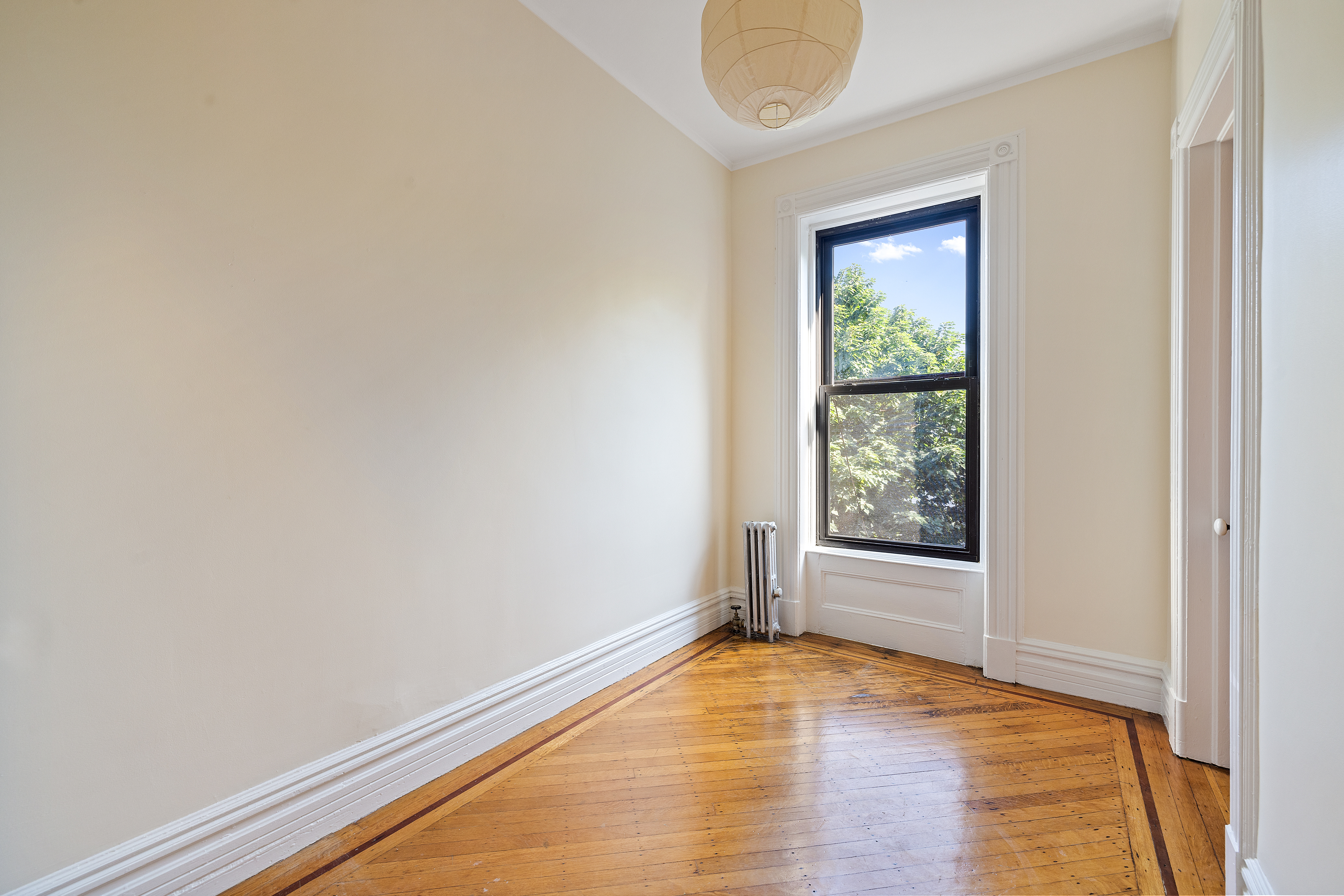 778 Quincy Street, Unit 2 Brooklyn, NY 11221 - Photo 8 of 14 an empty room with wooden floor and windows