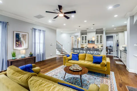 a living room with furniture and kitchen view