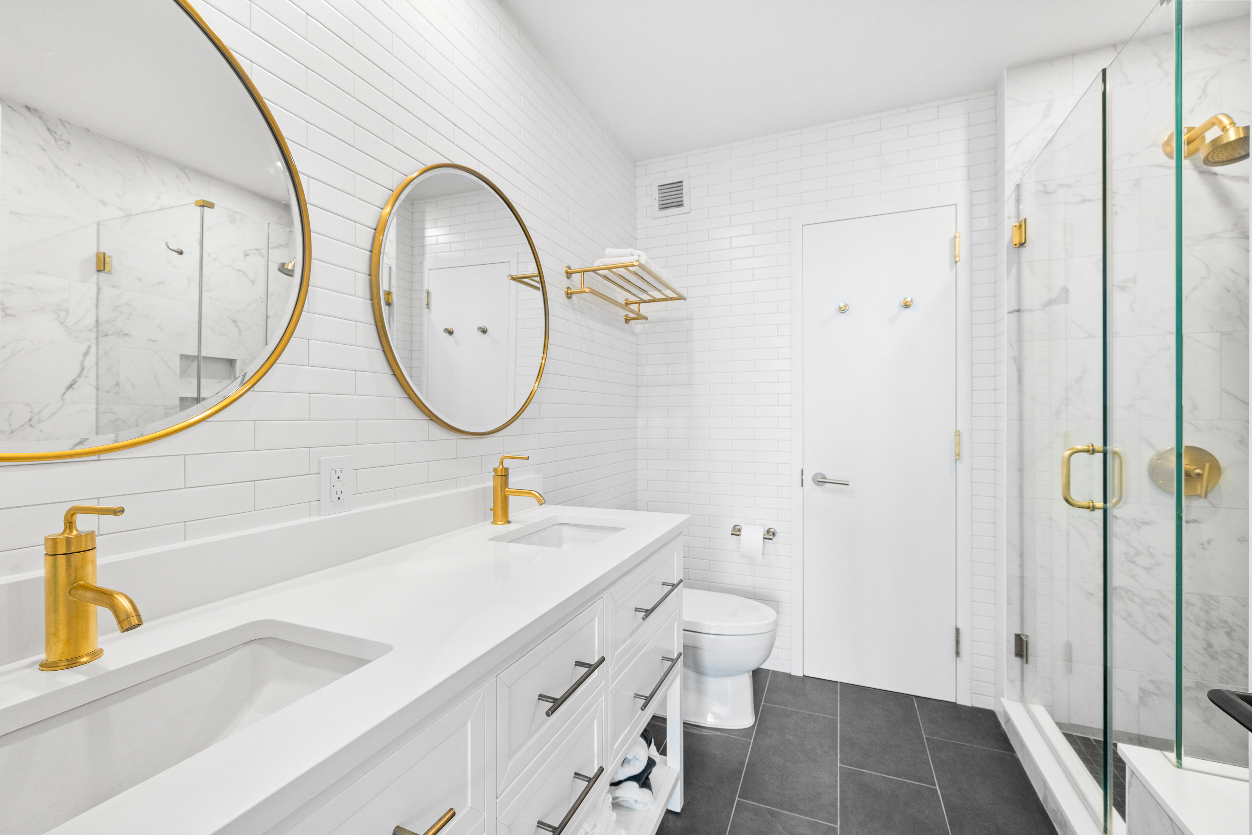 100 Jay Street, Unit 20F Brooklyn, NY 11201 - Photo 11 of 20 a bathroom with a sink a toilet and a mirror