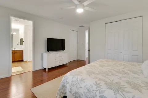 a bedroom with a bed and a flat screen tv