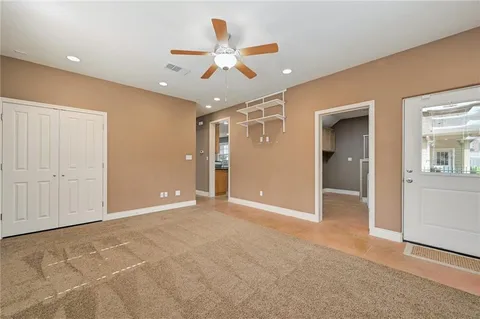 a view of an empty room with a ceiling fan