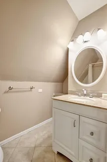 a bathroom with a sink a toilet a mirror and shower