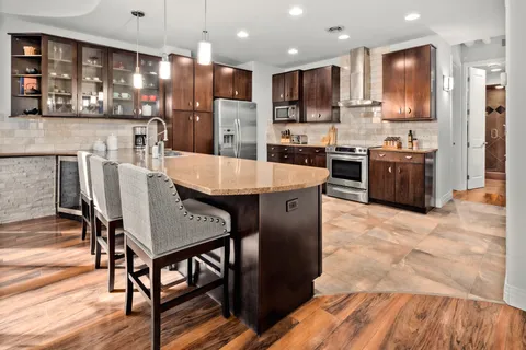 a large kitchen with a table and chairs