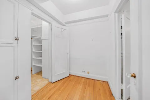 a view of a room with wooden floor and small space