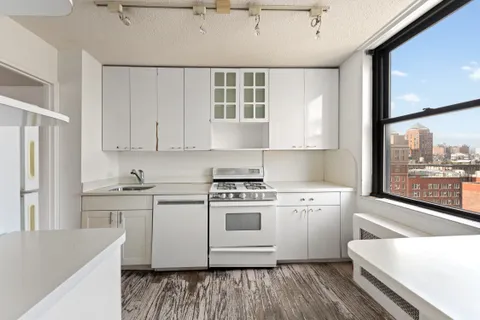 a kitchen with a stove a sink and a refrigerator