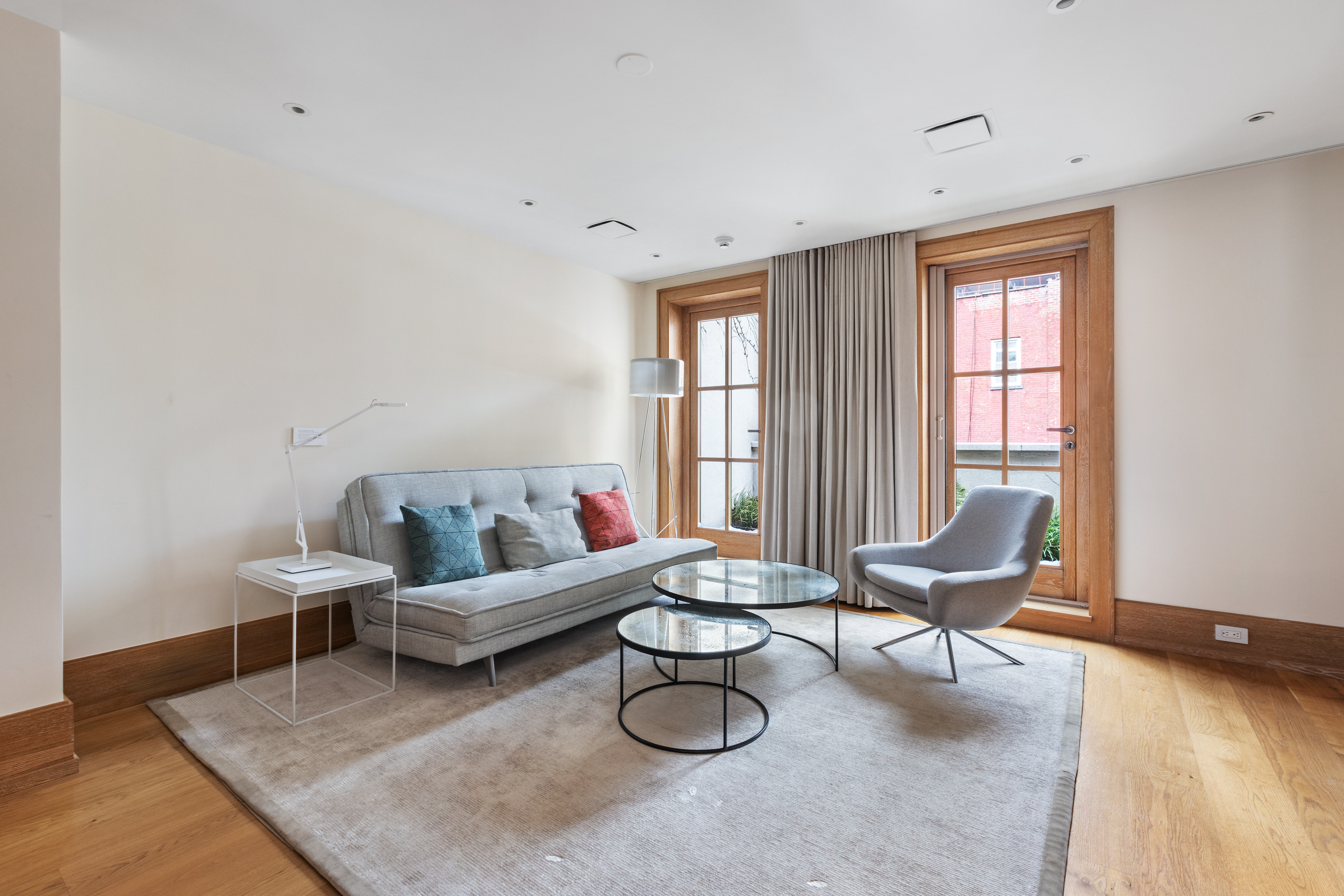 45 East 74th Street Manhattan, NY 10021 - Photo 25 of 33 a living room with furniture and a wooden floor