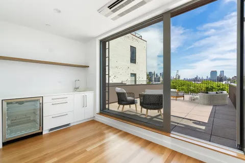 a view of a room with window and wooden floor